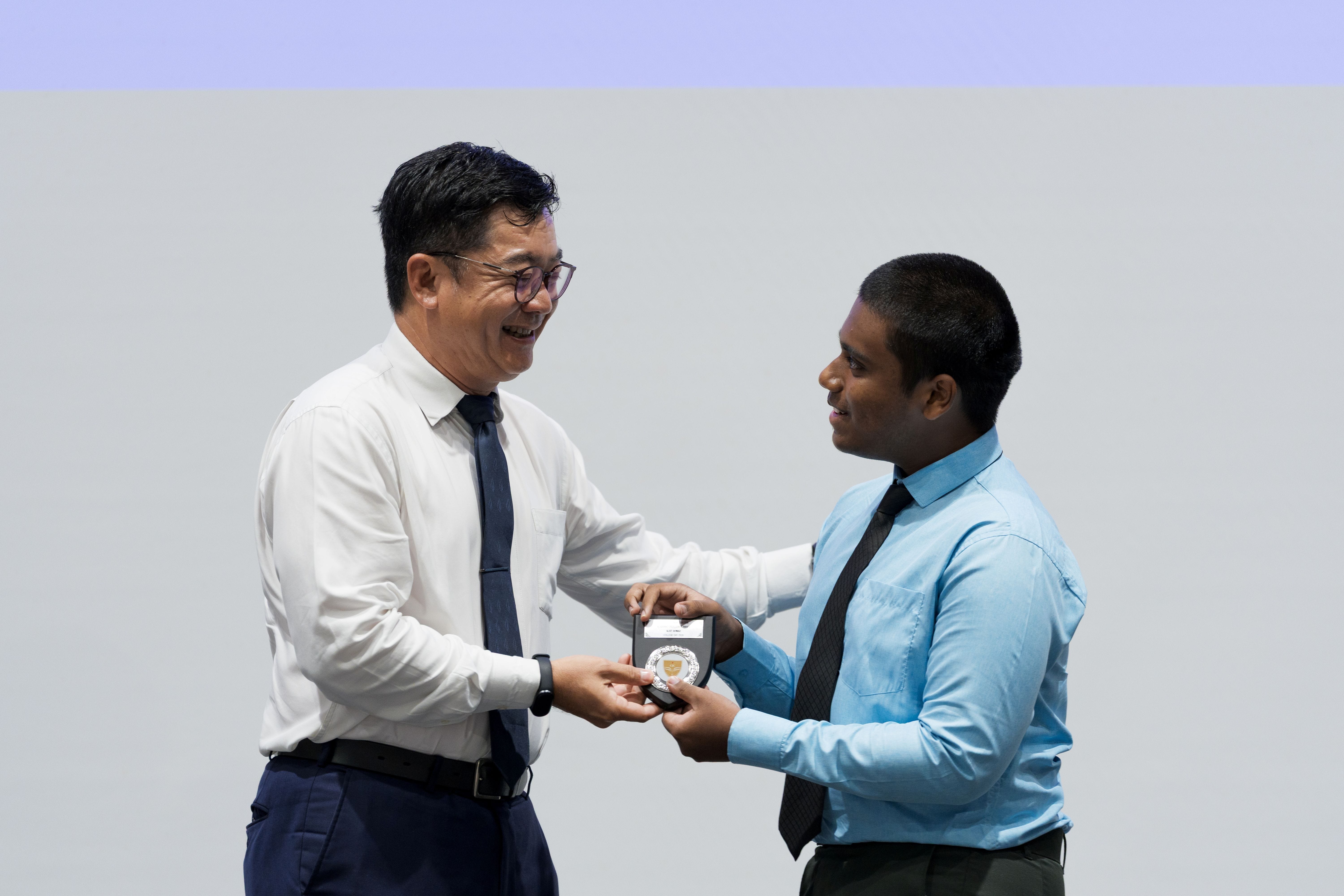 Mr Bernard Tan presenting award to Alief Ahmad